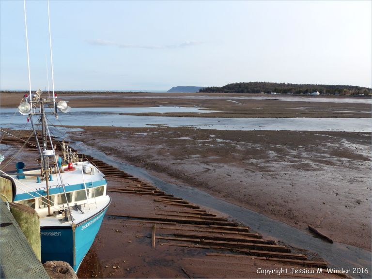 Beachscape with moored boat at Parrsboro, Nova Scotia, Canada.