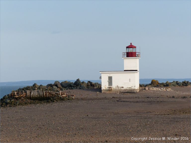 Beachscape with lighthouse at Parrsboro, Nova Scotia, Canada.