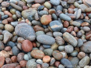 Wet pebbles at the water's edge at Pleasant Bay in Cape Breton Island