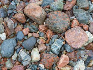 Ancient rocks of many types and colours on the river bed at Lone Shieling