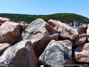 Texture and pattern in Devonian plutonic rocks used as rip-rap at White Point Harbour in Cape Breton Island, Nova Scotia, Canada.