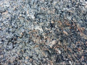 Close-up of texture and pattern in Devonian plutonic rocks used as rip-rap at White Point Harbour in Cape Breton Island, Nova Scotia, Canada.