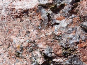 Close-up of texture and pattern in Devonian plutonic rocks used as rip-rap at White Point Harbour in Cape Breton Island, Nova Scotia, Canada.
