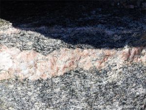 Close-up of texture and pattern in Devonian plutonic rocks used as rip-rap at White Point Harbour in Cape Breton Island, Nova Scotia, Canada.