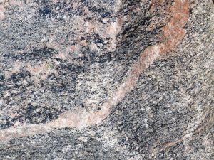 Close-up of texture and pattern in Devonian plutonic rocks used as rip-rap at White Point Harbour in Cape Breton Island, Nova Scotia, Canada.