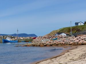 View of the harbour at White Pont in Cape Breton with rip-rap boulders of granitic pluton rock.