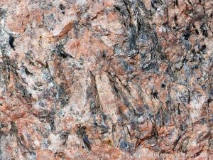 Close-up of texture and pattern in Devonian plutonic rocks used as rip-rap at White Point Harbour in Cape Breton Island, Nova Scotia, Canada.