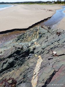 View from the basalt outcrop across the beach at Main a Dieu, Cape Breton Island, Nova Scotia, Canada.