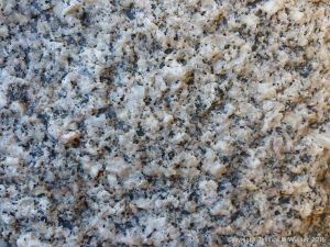 Macro photograph of natural rock pattern and texture in Herm Granodiorite