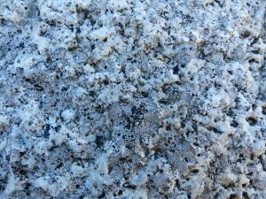 Macro photograph of natural rock pattern and texture in Herm Granodiorite