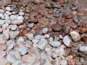 Contrasting wet and dry granite pebbles on the water's edge at Black Brook Cove