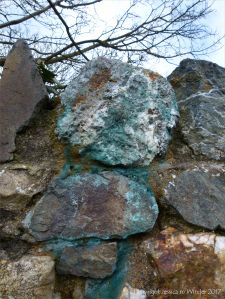 Stone wall with blue copper-stained quartz rock