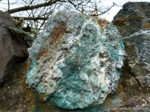 Blue copper-stained quartz rock in a stone wall