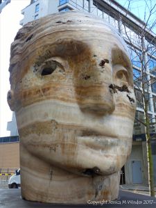 Carved head called Tempesta made from clastic igneous rock by Emily Young