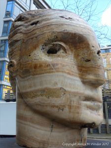 Carved head called Tempesta made from clastic igneous rock by Emily Young