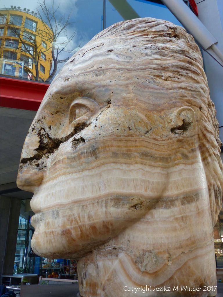 Carved head called Tempesta made from clastic igneous rock by Emily Young