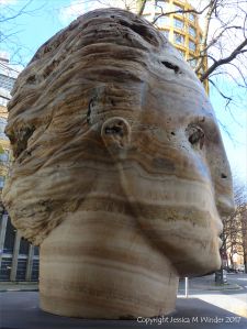 Carved head called Tempesta made from clastic igneous rock by Emily Young