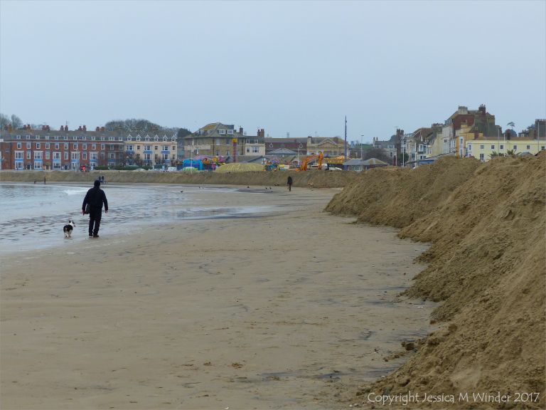 Piles of imported sand on Weymouth Beach