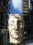 Carved stone head by Emily Young displayed at Neo Bankside in London