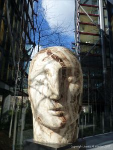 Carved stone head by Emily Young displayed at Neo Bankside in London