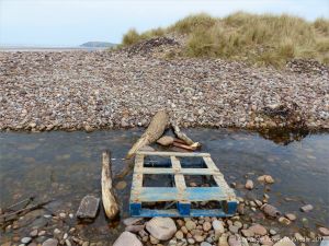 Makeshift bridge over Diles Lake stream on Rhossili beach