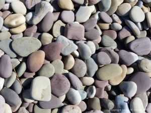 Pebbles on the seashore at Rhossili Bay in Gower, South Wales