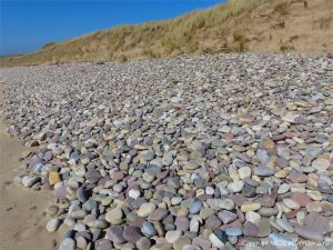 Pebbles on the seashore at Rhossili Bay in Gower, South Wales