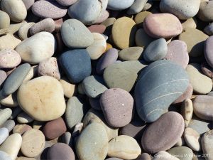 Pebbles on the seashore at Rhossili Bay in Gower, South Wales