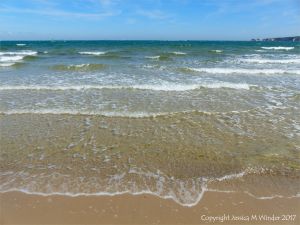 Sea, sand, and blue sky at Studland Bay in Dorset.