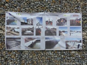 Natural pebbles and decorative hand-made ceramic pebbles in wire cages called gabions