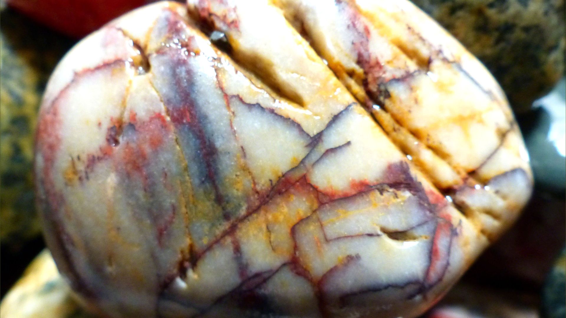 White pebble with red and yellow staining