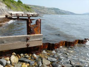 Rusting ironwork on a wooden breakwater