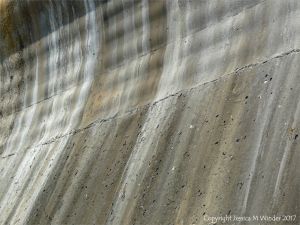 Natural pattern of stripes on a concrete sea wall