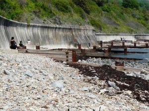 Wooden breakwaters with rusty iron fittings on the seashore