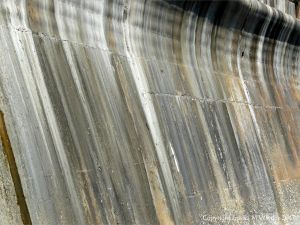 Natural pattern of stripes on an old concrete sea wall