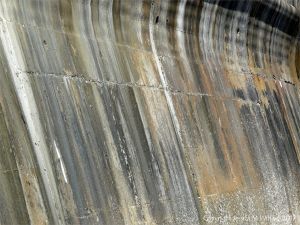 Natural pattern of stripes on an old concrete sea wall