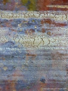 Pattern and texture of dried sea foam on rusty iron
