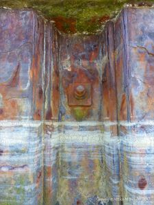 Lines of dried sea foam on a rusty iron pier