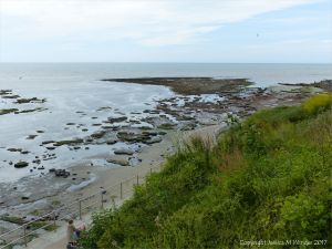 View looking down on the rocky shore below the new sea wall at Lyme Regis