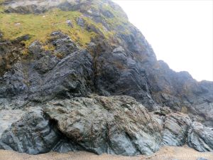 View of the Traboe Formation rocks with hornblende schist on the south side of Polurrian Cove in Cornwall