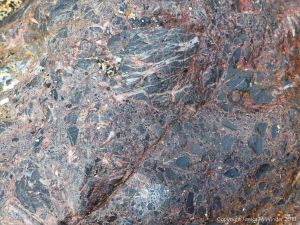 Close-up of boulder or outcrop of brecciated rock on the beach at Polurrian Cove