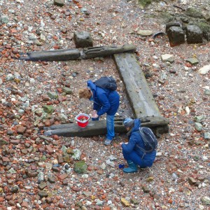 Two people looking for interesting objects on the Thames foreshore.
