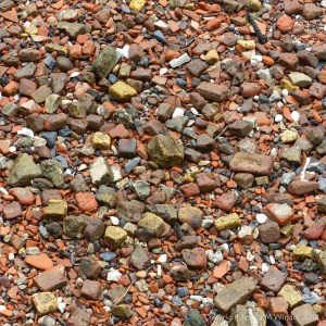 Old building and domestic debris is a major constituent of a stretch of tidally exposed shore on the River Thames