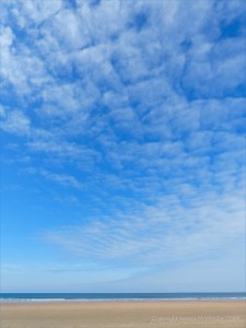 Rhossili Beach on a summer day showing big blue sky