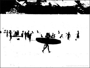Black and white image of people with surf boards on the water's edge at the beach