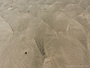 Rhossili Beach on a summer day showing patterns on the sand