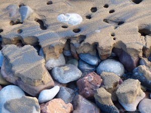 Beach pebbles covered with sand