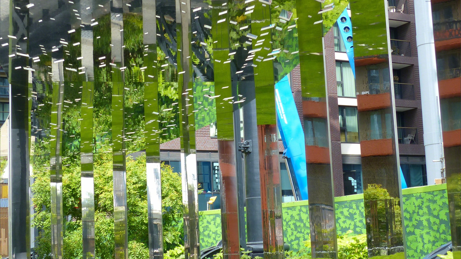 A circular mirrored garden in the structural framework of an old gasometer