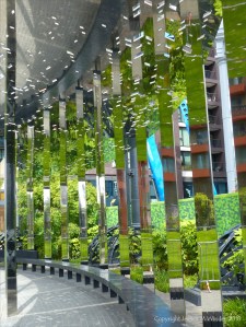 A circular mirrored garden in the structural framework of an old gasometer