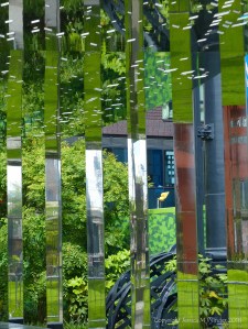 A circular mirrored garden in the structural framework of an old gasometer